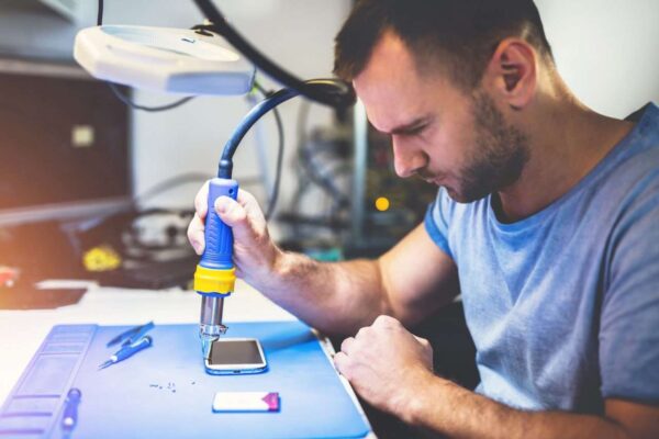 man-repairing-smartphone-at-workplace.jpg